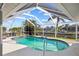 A screened-in pool area with a clear view of the canal and surrounding palm trees, perfect for relaxation and outdoor entertainment at 400 Coronado Dr, Punta Gorda, FL 33950