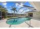 Inviting pool with screened lanai overlooking the tranquil canal and lush tropical landscaping at 400 Coronado Dr, Punta Gorda, FL 33950