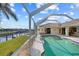 Enclosed pool overlooks the canal, providing a serene view and ample space for outdoor relaxation and entertainment at 400 Coronado Dr, Punta Gorda, FL 33950