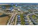Aerial view of community, featuring homes, lake, amenities, and nearby school at 43104 Lakeside Way, Punta Gorda, FL 33982