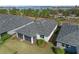 Aerial view showing home's backyard, screened patio, and landscaping at 43104 Lakeside Way, Punta Gorda, FL 33982