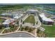 Aerial view of community with school, sports fields, and lake at 43104 Lakeside Way, Punta Gorda, FL 33982