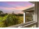 View of backyard with lush landscaping at sunset at 43104 Lakeside Way, Punta Gorda, FL 33982