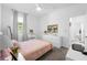Spacious bedroom with a bed, dresser, and access to another room at 43104 Lakeside Way, Punta Gorda, FL 33982