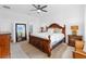 King-size bed, wood furniture, and large window with a view at 43104 Lakeside Way, Punta Gorda, FL 33982