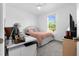 Light and airy bedroom with a desk, bed, and a large window at 43104 Lakeside Way, Punta Gorda, FL 33982