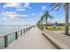 Peaceful waterfront boardwalk with a bench for relaxing at 43104 Lakeside Way, Punta Gorda, FL 33982