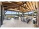 Covered patio overlooking a lake with seating and outdoor fireplace at 43104 Lakeside Way, Punta Gorda, FL 33982