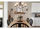 Elegant dining room features a rustic farmhouse table and chandelier at 43104 Lakeside Way, Punta Gorda, FL 33982