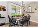 Bright dining room with farmhouse table, chandelier, and access to backyard at 43104 Lakeside Way, Punta Gorda, FL 33982