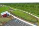 Aerial view of a fenced dog park with agility equipment and a shelter at 43104 Lakeside Way, Punta Gorda, FL 33982