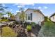 Landscaped yard with a white house exterior and a two car garage at 43104 Lakeside Way, Punta Gorda, FL 33982
