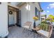 Welcoming front porch with wicker chairs and a small table at 43104 Lakeside Way, Punta Gorda, FL 33982
