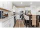 Modern kitchen with white cabinets, stainless steel appliances, and kitchen island at 43104 Lakeside Way, Punta Gorda, FL 33982