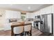 Modern kitchen with white cabinets, stainless steel appliances, and kitchen island at 43104 Lakeside Way, Punta Gorda, FL 33982