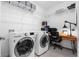 Bright laundry room with washer, dryer, and built-in workspace at 43104 Lakeside Way, Punta Gorda, FL 33982