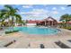 Relaxing resort-style pool with lounge chairs and a shaded seating area at 43104 Lakeside Way, Punta Gorda, FL 33982