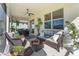 Covered patio with wicker furniture and potted plants at 43104 Lakeside Way, Punta Gorda, FL 33982
