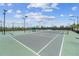 Expansive tennis courts with shaded seating areas at 43104 Lakeside Way, Punta Gorda, FL 33982
