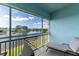 Enjoy the lake view from this screened balcony with comfortable lounge seating at 5738 Sabal Trace Dr # 204B57, North Port, FL 34287