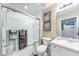 Clean bathroom with a shower over tub, sliding glass door, and modern vanity with good lighting at 5738 Sabal Trace Dr # 204B57, North Port, FL 34287
