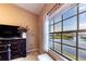Bedroom featuring a waterfront view of the lake and fountain through a large window at 5738 Sabal Trace Dr # 204B57, North Port, FL 34287