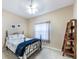 Cozy bedroom with soft carpet, a comfortable bed, and a ladder-style shelving unit for storage at 5738 Sabal Trace Dr # 204B57, North Port, FL 34287