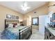 Bedroom featuring a bed, dresser, mirror and ceiling fan with natural light at 5738 Sabal Trace Dr # 204B57, North Port, FL 34287