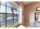 Bedroom featuring a large window showcasing a beautiful lake view and a bright, neutral interior at 5738 Sabal Trace Dr # 204B57, North Port, FL 34287