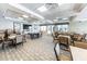Resident clubhouse with tables, chairs, TV, neutral wall color, and carpeted floors at 5738 Sabal Trace Dr # 204B57, North Port, FL 34287