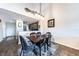 Dining area with hardwood table and chairs and view into kitchen with dark wood cabinets at 5738 Sabal Trace Dr # 204B57, North Port, FL 34287