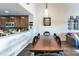 Dining room featuring a large wooden table, with adjacent kitchen and living room at 5738 Sabal Trace Dr # 204B57, North Port, FL 34287