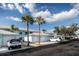 Charming condo community featuring blue buildings, garages, and mature palm trees at 5738 Sabal Trace Dr # 204B57, North Port, FL 34287