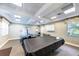 Resident game room with a pool table and ping pong table under bright lights with neutral walls at 5738 Sabal Trace Dr # 204B57, North Port, FL 34287