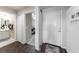 Bright hallway leading to a bathroom and rooms with wood floors and white trim, offering a welcoming entrance at 5738 Sabal Trace Dr # 204B57, North Port, FL 34287