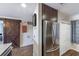 Kitchen features stainless steel refrigerator, wood look ceramic tile floors, and access to barn door at 5738 Sabal Trace Dr # 204B57, North Port, FL 34287