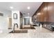Modern kitchen featuring granite countertops, stainless steel appliances, and wood look ceramic tile flooring at 5738 Sabal Trace Dr # 204B57, North Port, FL 34287