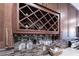 Close up of the kitchen wine rack featuring wooden cabinetry, a wine rack and glasses with granite countertops at 5738 Sabal Trace Dr # 204B57, North Port, FL 34287