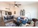 Spacious living room featuring an open floor plan, wood floors, a ceiling fan, and a cozy seating area at 5738 Sabal Trace Dr # 204B57, North Port, FL 34287