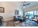 Comfortable living room featuring a ceiling fan, wood flooring, and a large window with beautiful views at 5738 Sabal Trace Dr # 204B57, North Port, FL 34287