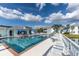 Exterior view of outdoor pool with lounge chairs and tables and chairs surrounding it in this residential community at 5738 Sabal Trace Dr # 204B57, North Port, FL 34287