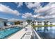 View of the outdoor community pool, lounge chairs and attractive landscaping. The pool sits next to a body of water at 5738 Sabal Trace Dr # 204B57, North Port, FL 34287