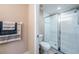 Neat and compact shower room showcases a glass door shower, white toilet, and towel hangers at 5738 Sabal Trace Dr # 204B57, North Port, FL 34287