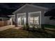 Craftsman style home at night with teal front door at 706 W Madison St, Plant City, FL 33563