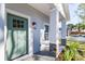 Quaint front porch with a teal door and stone columns at 706 W Madison St, Plant City, FL 33563