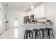 Modern kitchen with white cabinets, granite counters, and stainless steel appliances at 706 W Madison St, Plant City, FL 33563