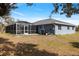Expansive backyard featuring a screened-in lanai with a pool and hot tub, perfect for outdoor relaxation and entertainment at 9 Logan St, Port Charlotte, FL 33954