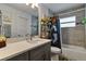 Updated bathroom featuring modern vanity, stone-look tiles, and a shower-tub combination at 9 Logan St, Port Charlotte, FL 33954
