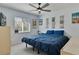 The spacious bedroom has large windows with a ceiling fan and serene decor at 9 Logan St, Port Charlotte, FL 33954