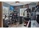 This versatile bonus room features a ceiling fan, gym equipment, and a home office setup at 9 Logan St, Port Charlotte, FL 33954